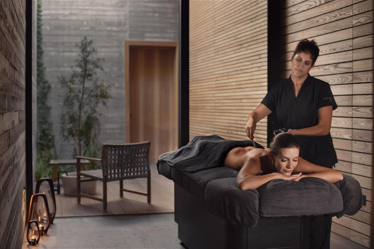 Minthis Resort Tsadha Exterior photo A massage therapist at work
